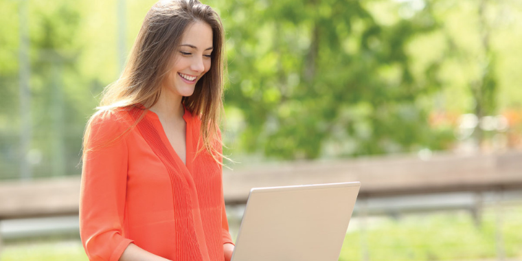 Student on laptop while outside. 